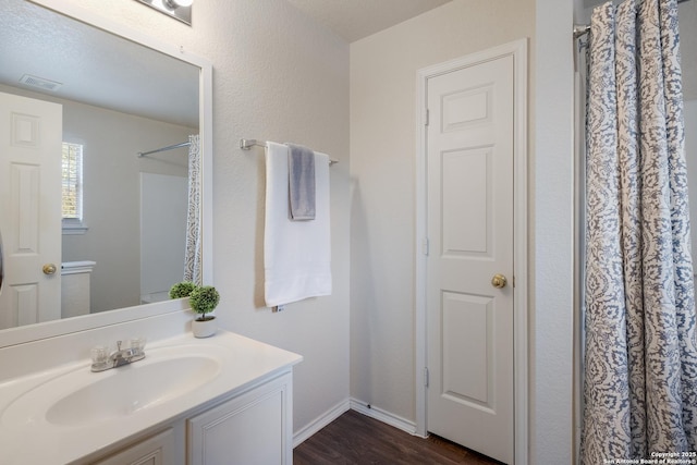 135 Agency Oaks, San Antonio, TX 78249 - bathroom with vanity, wood finished floors, curtained shower, and baseboards