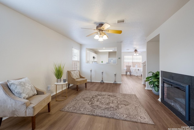 135 Agency Oaks, San Antonio, TX 78249 - sitting room featuring healthy amount of natural light, a ceiling fan, wood finished floors, and baseboards