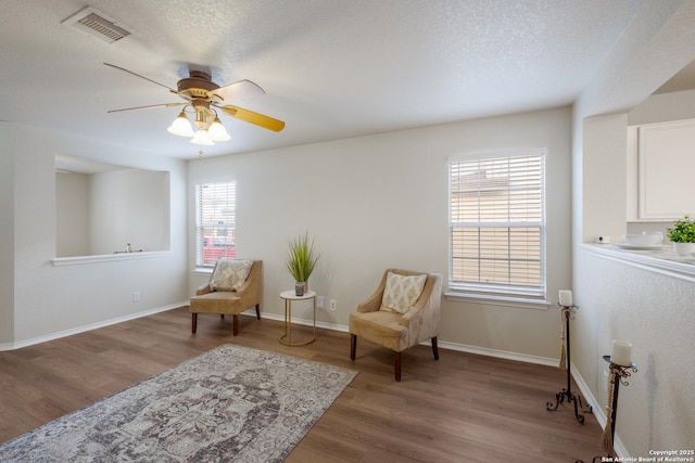 135 Agency Oaks, San Antonio, TX 78249 - living area with a ceiling fan, wood finished floors, a textured ceiling, and baseboards