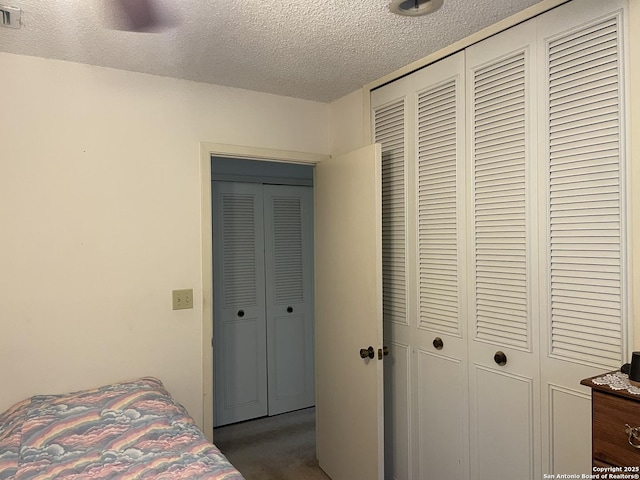 6823 S Whitland, San Antonio, TX 78239 - bedroom with a textured ceiling, a closet, and dark carpet