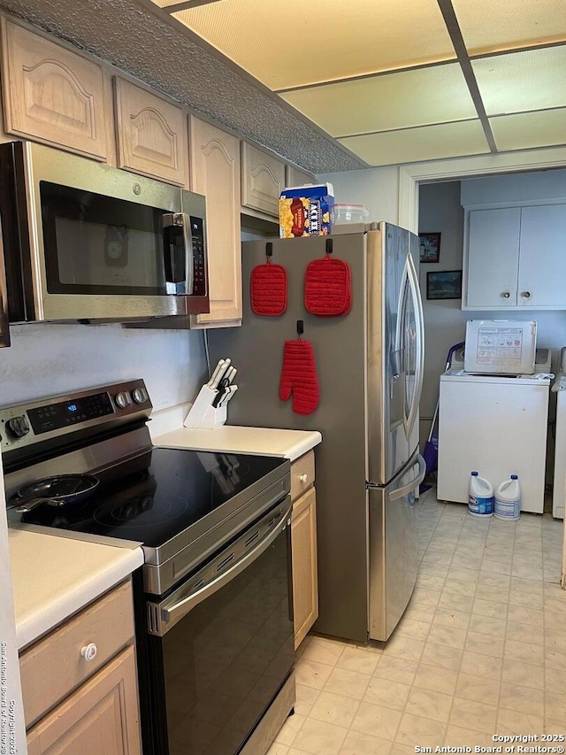 6823 S Whitland, San Antonio, TX 78239 - kitchen with appliances with stainless steel finishes, light countertops, light floors, and washing machine and dryer