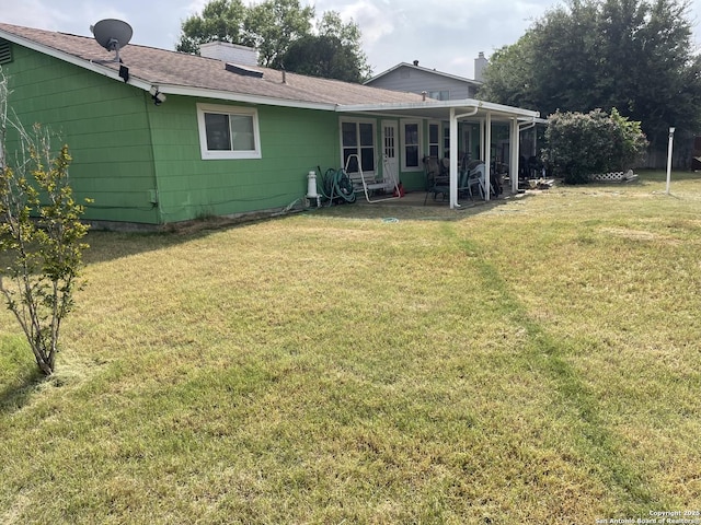 6823 S Whitland, San Antonio, TX 78239 - back of property featuring a chimney, a patio area, a yard, and a shingled roof