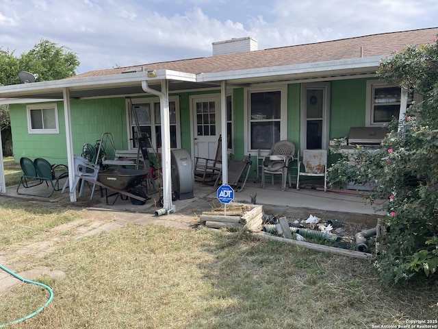 6823 S Whitland, San Antonio, TX 78239 - back of property featuring a porch, roof with shingles, a yard, and a chimney
