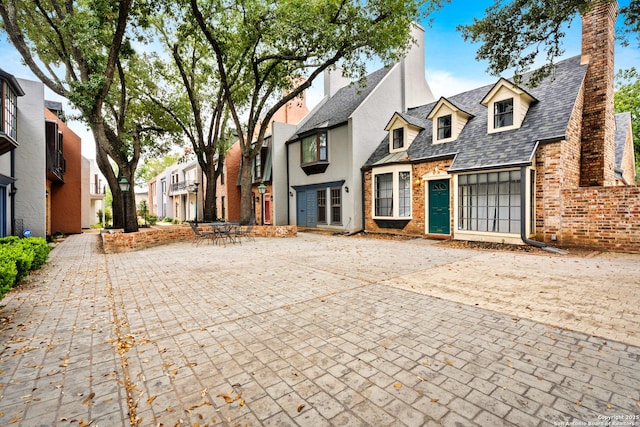 1170 Garraty Rd Unit 14, San Antonio, TX 78209 - view of front of house with a residential view, a chimney, and brick siding