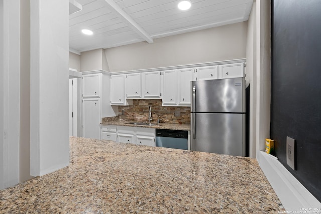 1170 Garraty Rd Unit 14, San Antonio, TX 78209 - kitchen with stainless steel appliances, a sink, light stone countertops, tasteful backsplash, and white cabinetry