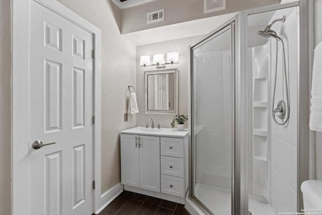 1170 Garraty Rd Unit 14, San Antonio, TX 78209 - full bathroom with a shower stall, vanity, baseboards, wood finished floors, and toilet