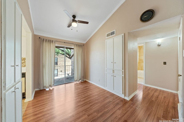 9419 Powhatan Unit 504, San Antonio, TX 78230 - empty room with ornamental molding, light wood-type flooring, a ceiling fan, lofted ceiling, and baseboards