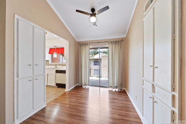 9419 Powhatan Unit 504, San Antonio, TX 78230 - spare room with ornamental molding, a ceiling fan, vaulted ceiling, light wood-style floors, and baseboards