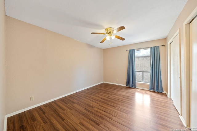 9419 Powhatan Unit 504, San Antonio, TX 78230 - spare room featuring ceiling fan, baseboards, and wood finished floors