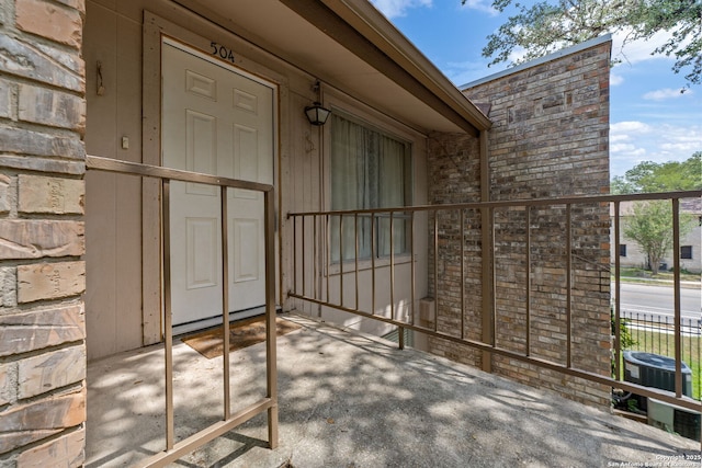 9419 Powhatan Unit 504, San Antonio, TX 78230 - view of exterior entry featuring central air condition unit and stone siding