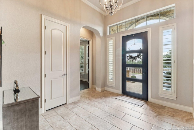 24227 Vecchio, San Antonio, TX 78260 - foyer entrance with ornamental molding, arched walkways, a chandelier, and baseboards
