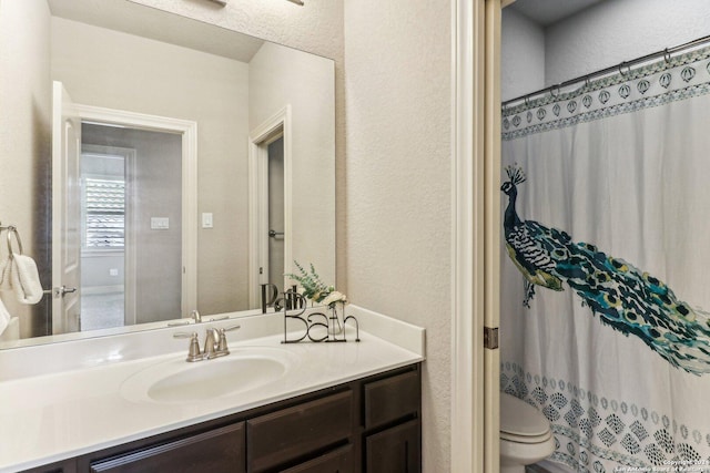 24227 Vecchio, San Antonio, TX 78260 - full bath with vanity, toilet, a textured wall, and a shower with shower curtain