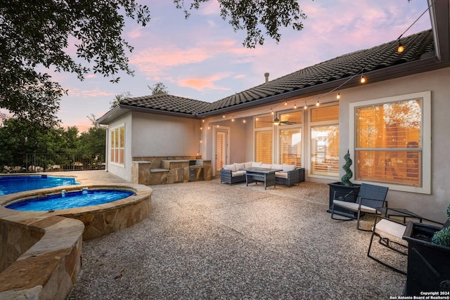 24227 Vecchio, San Antonio, TX 78260 - back of property at dusk featuring an outdoor living space, a tile roof, stucco siding, and a patio