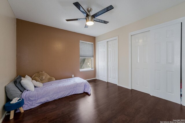 4107 Medical Dr Unit 2204, San Antonio, TX 78229 - bedroom featuring dark wood finished floors, two closets, baseboards, and a ceiling fan