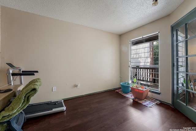 4107 Medical Dr Unit 2204, San Antonio, TX 78229 - exercise area featuring a textured ceiling and wood finished floors