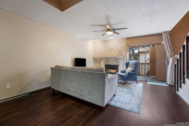 4107 Medical Dr Unit 2204, San Antonio, TX 78229 - living room featuring ceiling fan, wood finished floors, a fireplace, and a textured ceiling