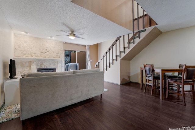 4107 Medical Dr Unit 2204, San Antonio, TX 78229 - living area with ceiling fan, stairway, a stone fireplace, a textured ceiling, and wood finished floors