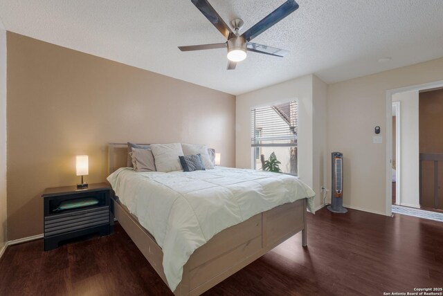 4107 Medical Dr Unit 2204, San Antonio, TX 78229 - bedroom with wood finished floors, a textured ceiling, baseboards, and ceiling fan