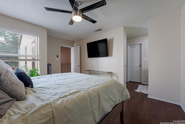 4107 Medical Dr Unit 2204, San Antonio, TX 78229 - bedroom with dark wood finished floors, a textured ceiling, a ceiling fan, and baseboards