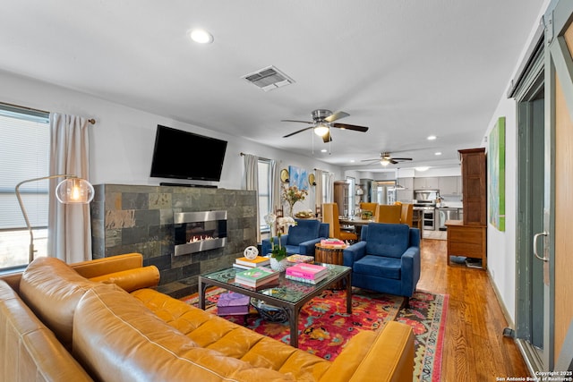 221 Calumet, San Antonio, TX 78209 - living area featuring recessed lighting, a lit fireplace, light wood-type flooring, and ceiling fan
