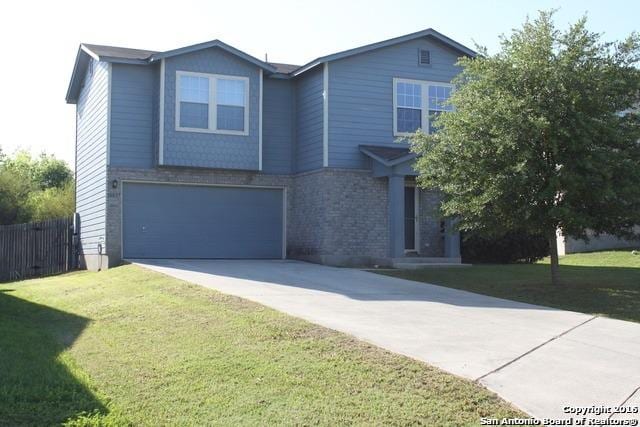 10047 Powderhouse Dr, San Antonio, TX 78239 - view of front of house featuring concrete driveway, a garage, and brick siding