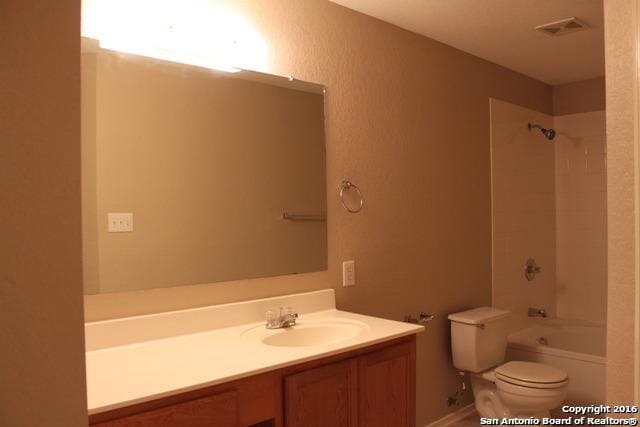 10047 Powderhouse Dr, San Antonio, TX 78239 - full bathroom with toilet, vanity, and tub / shower combination