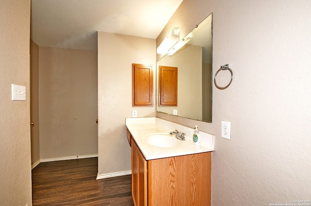 10047 Powderhouse Dr, San Antonio, TX 78239 - bathroom with vanity, wood finished floors, and baseboards