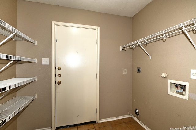 10047 Powderhouse Dr, San Antonio, TX 78239 - laundry area with electric dryer hookup, washer hookup, tile patterned floors, and baseboards