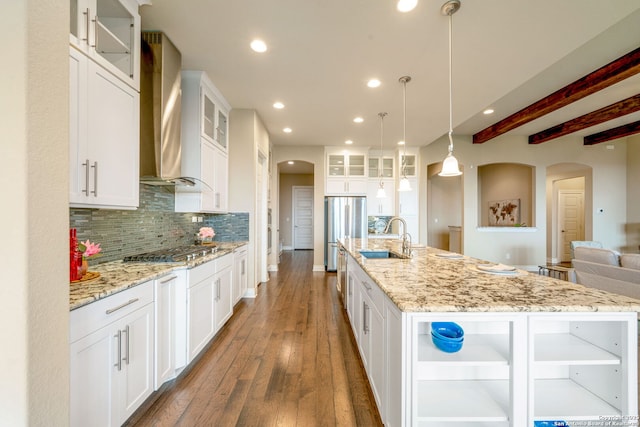 3122 Running Fawn, San Antonio, TX 78261 - kitchen with arched walkways, a sink, wall chimney exhaust hood, stainless steel appliances, and backsplash