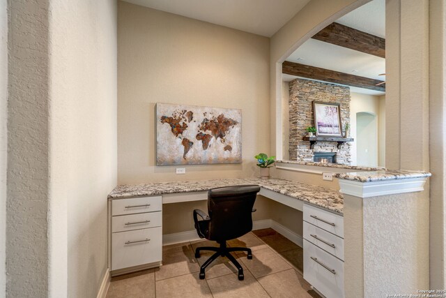 3122 Running Fawn, San Antonio, TX 78261 - office featuring built in desk, light tile patterned floors, beam ceiling, arched walkways, and baseboards