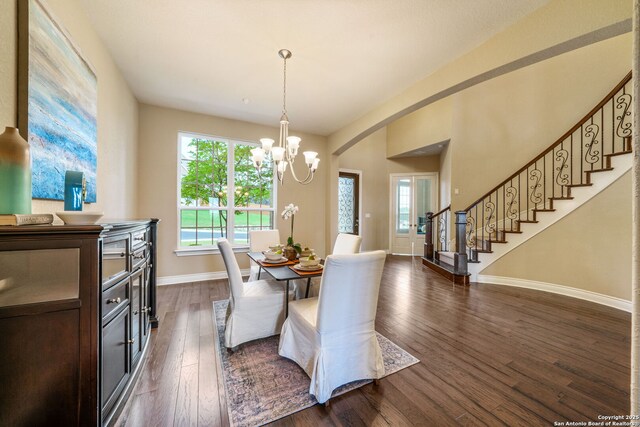 3122 Running Fawn, San Antonio, TX 78261 - dining area with a chandelier, stairway, dark wood finished floors, baseboards, and arched walkways