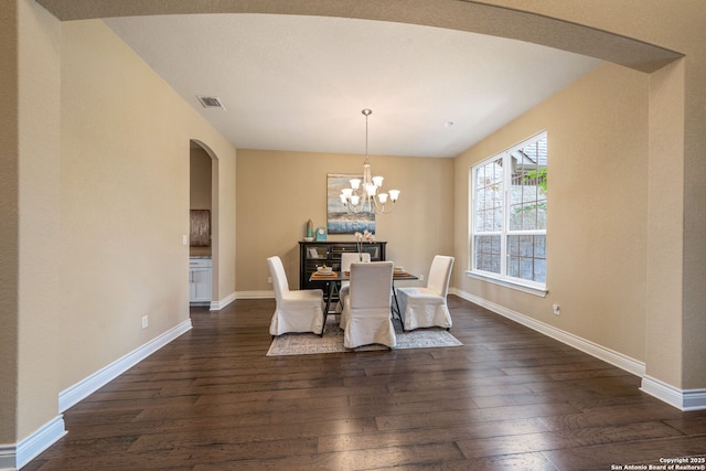 3122 Running Fawn, San Antonio, TX 78261 - dining area with arched walkways, dark wood finished floors, a chandelier, and baseboards
