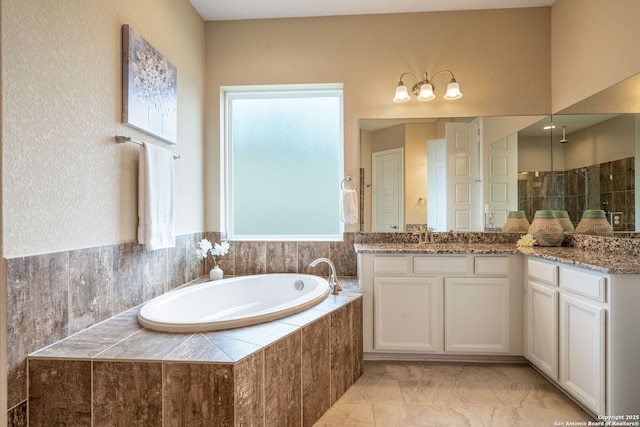 3122 Running Fawn, San Antonio, TX 78261 - full bathroom with vanity, a bath, tiled shower, and marble look tiles