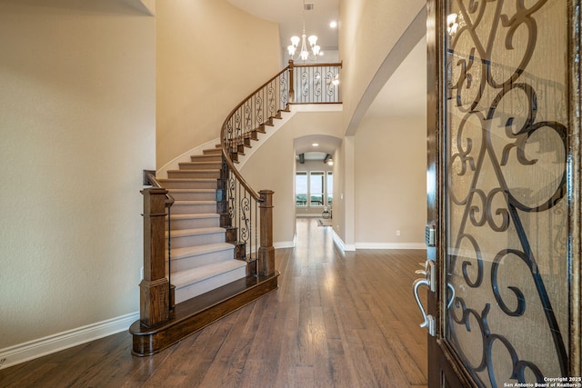 3122 Running Fawn, San Antonio, TX 78261 - entryway featuring arched walkways, hardwood / wood-style floors, baseboards, stairway, and a towering ceiling