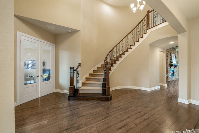 3122 Running Fawn, San Antonio, TX 78261 - entrance foyer featuring arched walkways, wood finished floors, french doors, stairs, and a towering ceiling