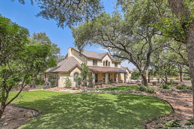 12424 Andice, Helotes, TX 78023 - view of front of house with a porch, a front lawn, stone siding, a standing seam roof, and stucco siding