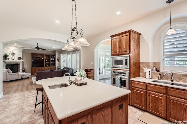 12424 Andice, Helotes, TX 78023 - kitchen with appliances with stainless steel finishes, a sink, arched walkways, ceiling fan, and recessed lighting