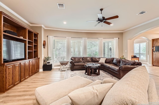 12424 Andice, Helotes, TX 78023 - living room featuring arched walkways, ceiling fan, crown molding, light wood-style flooring, and baseboards
