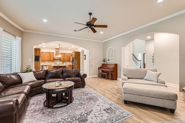 12424 Andice, Helotes, TX 78023 - living room featuring arched walkways, a ceiling fan, light wood-style floors, recessed lighting, and baseboards