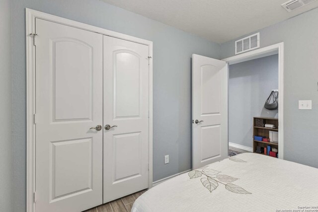 3402 Red Fls, San Antonio, TX 78253 - bedroom with dark wood finished floors, a closet, and baseboards