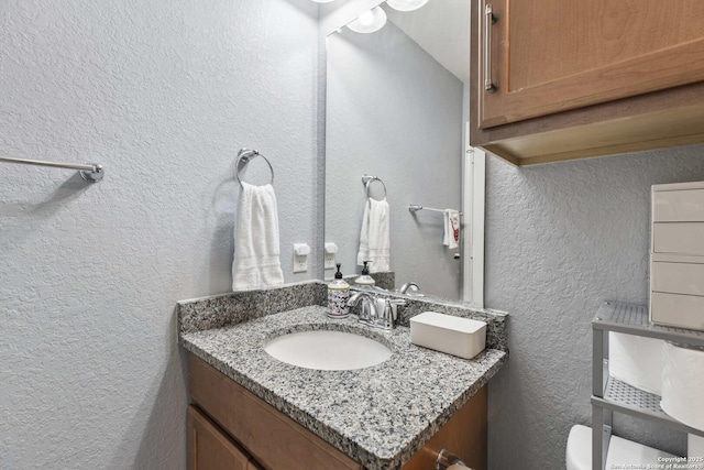 3402 Red Fls, San Antonio, TX 78253 - half bathroom featuring a textured wall, vanity, and toilet
