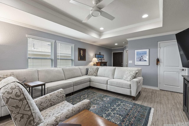 3402 Red Fls, San Antonio, TX 78253 - living room with a raised ceiling, light wood-style flooring, ceiling fan, crown molding, and baseboards