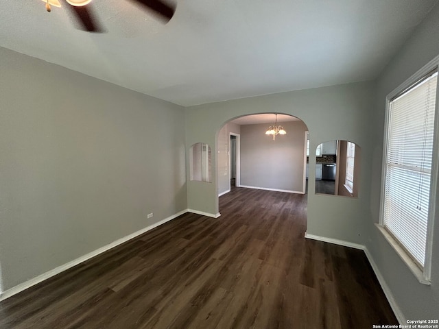 407 Westminster Ave, San Antonio, TX 78228 - empty room with arched walkways, dark wood finished floors, baseboards, and plenty of natural light