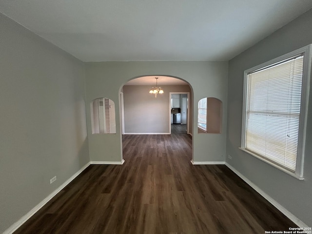 407 Westminster Ave, San Antonio, TX 78228 - spare room with arched walkways, dark wood finished floors, baseboards, and a chandelier