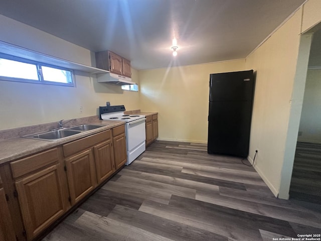 407 Westminster Ave, San Antonio, TX 78228 - kitchen with electric stove, a sink, under cabinet range hood, dark wood-type flooring, and freestanding refrigerator
