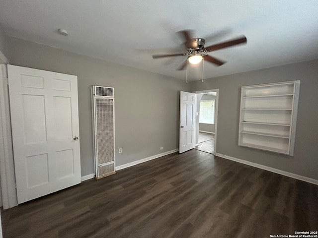 407 Westminster Ave, San Antonio, TX 78228 - unfurnished bedroom featuring a heating unit, baseboards, dark wood-type flooring, and a ceiling fan
