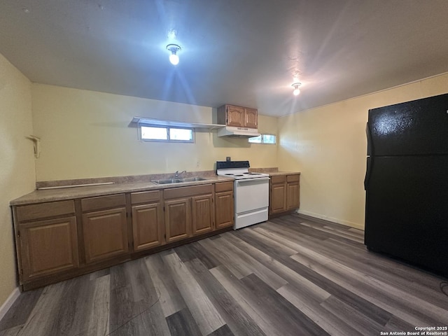 407 Westminster Ave, San Antonio, TX 78228 - kitchen featuring white range with electric cooktop, freestanding refrigerator, dark wood-style flooring, and under cabinet range hood