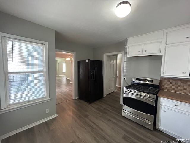 407 Westminster Ave, San Antonio, TX 78228 - kitchen with stainless steel gas stove, black fridge, dark wood-style floors, baseboards, and white cabinetry