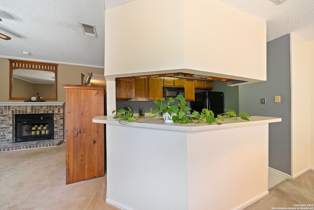 10955 Wurzbach Unit 905, San Antonio, TX 78230 - kitchen featuring black appliances, light colored carpet, a textured ceiling, a brick fireplace, and light countertops