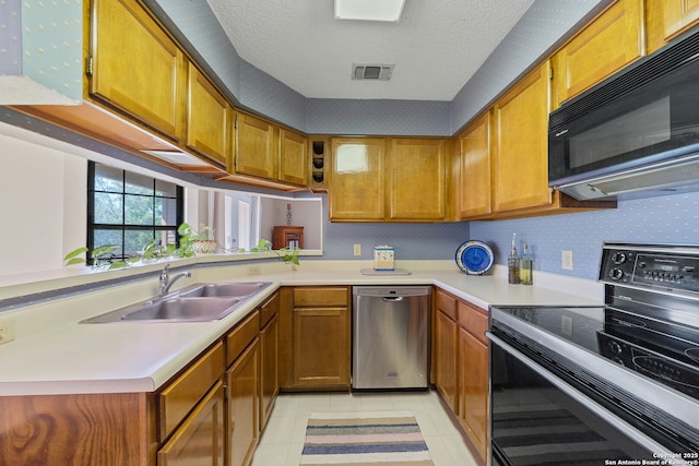 10955 Wurzbach Unit 905, San Antonio, TX 78230 - kitchen with dishwasher, electric range, black microwave, light countertops, and a sink